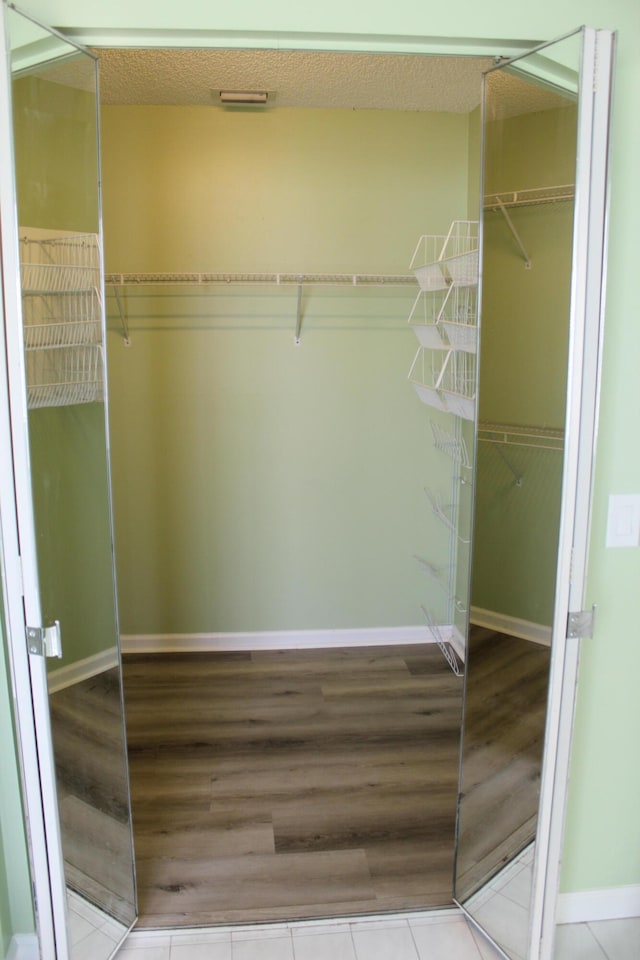 spacious closet with light hardwood / wood-style floors