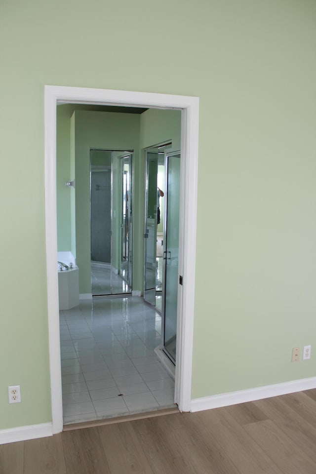 corridor featuring hardwood / wood-style floors