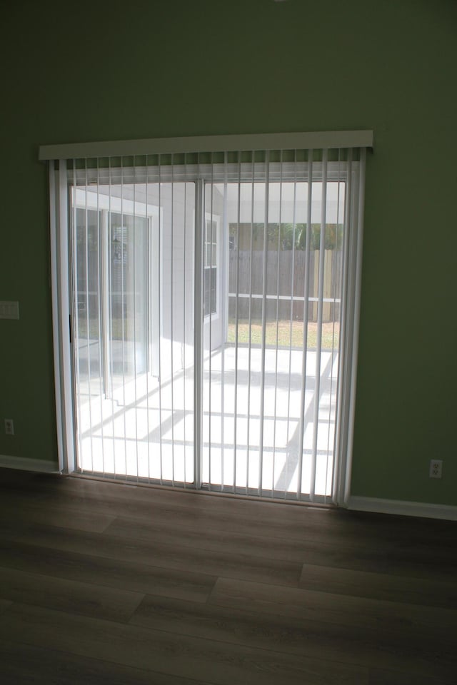 empty room with dark hardwood / wood-style floors