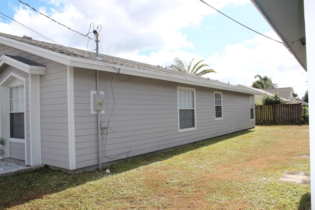 view of side of home featuring a yard