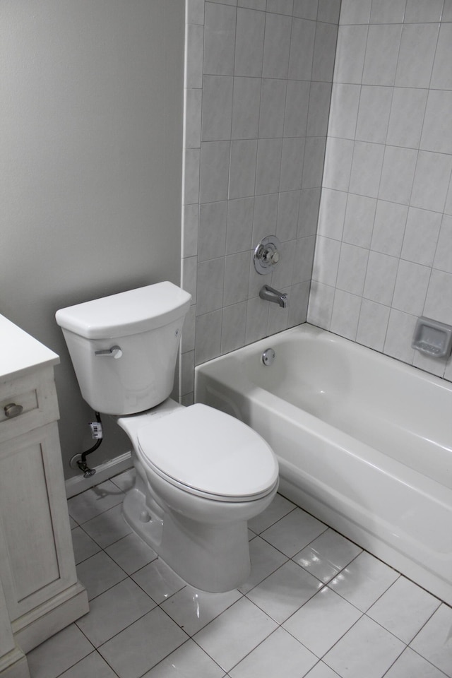 full bathroom featuring tile patterned flooring, vanity, toilet, and tiled shower / bath combo