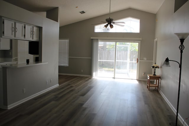 unfurnished living room featuring a textured ceiling, ceiling fan, high vaulted ceiling, and dark hardwood / wood-style floors