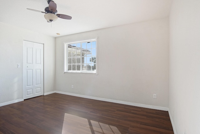 empty room featuring dark hardwood / wood-style floors and ceiling fan