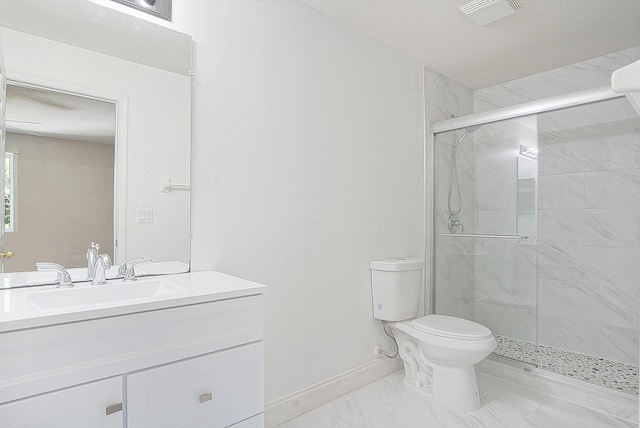 bathroom with a textured ceiling, vanity, toilet, and a shower with shower door