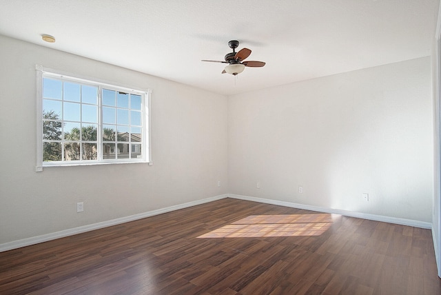 spare room with ceiling fan and dark wood-type flooring