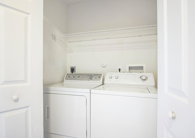 clothes washing area with independent washer and dryer