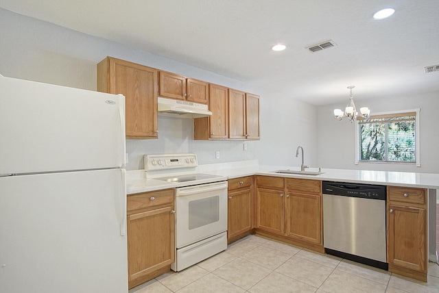 kitchen with white appliances, sink, hanging light fixtures, a notable chandelier, and light tile patterned flooring