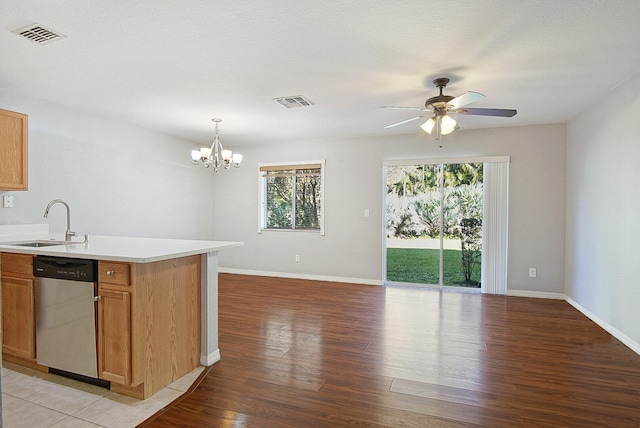 kitchen with dishwasher, light hardwood / wood-style floors, hanging light fixtures, and sink