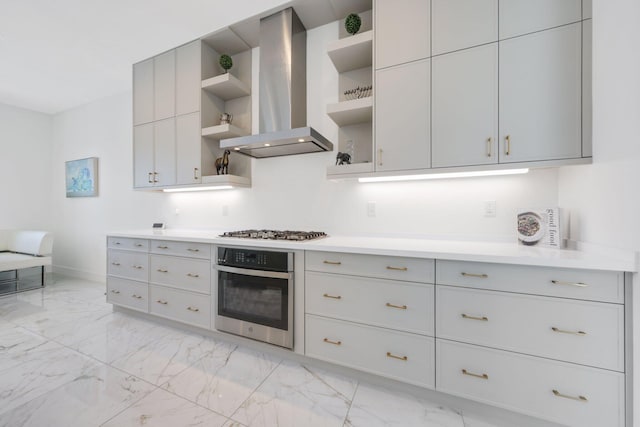 kitchen with gray cabinets, range hood, and appliances with stainless steel finishes