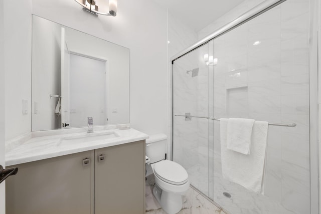 bathroom featuring vanity, toilet, and a shower with door