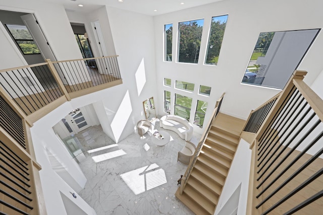 living room with a towering ceiling and a wealth of natural light