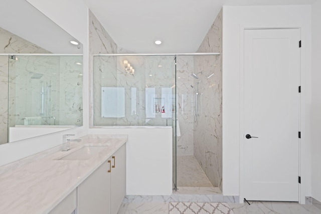 bathroom featuring vanity and a shower with shower door