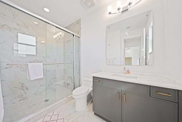 bathroom featuring vanity, a shower with shower door, and toilet