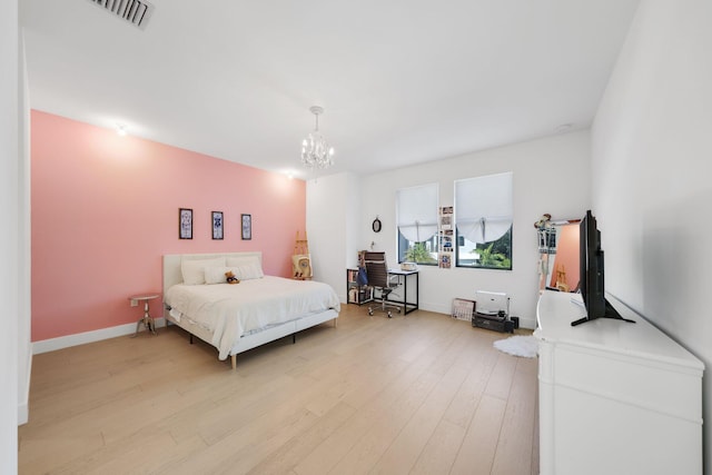 bedroom featuring light hardwood / wood-style flooring and a notable chandelier