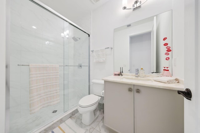 bathroom featuring vanity, an enclosed shower, and toilet