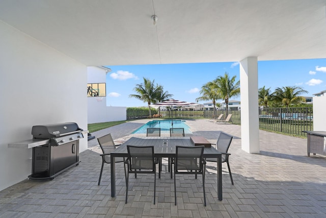 view of patio with a fenced in pool and a grill