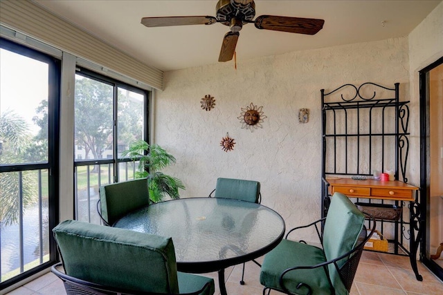 sunroom featuring ceiling fan