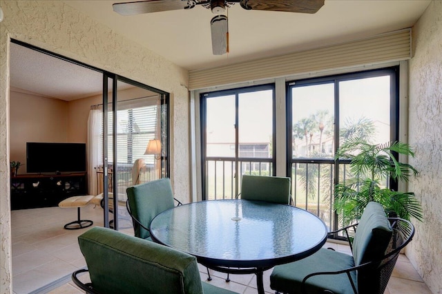 sunroom featuring a wealth of natural light and ceiling fan