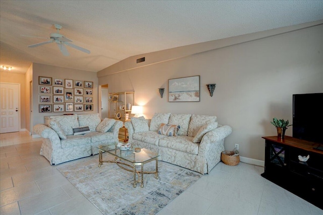 living room featuring ceiling fan, light tile patterned flooring, a textured ceiling, and vaulted ceiling