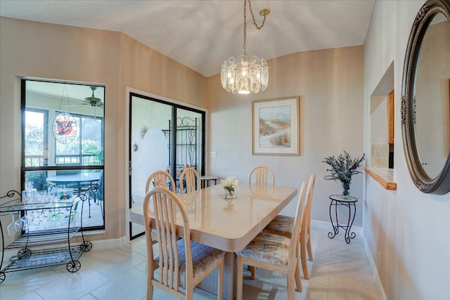 dining space with light tile patterned floors and an inviting chandelier