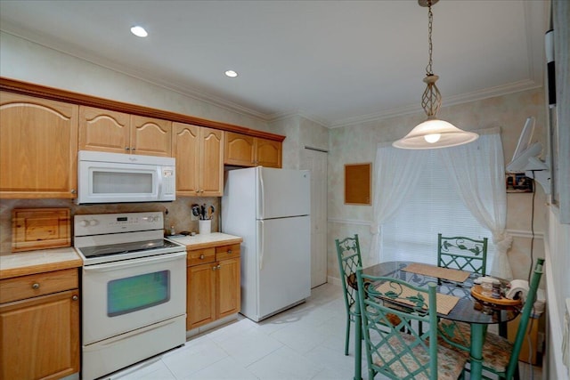 kitchen with pendant lighting, white appliances, and crown molding