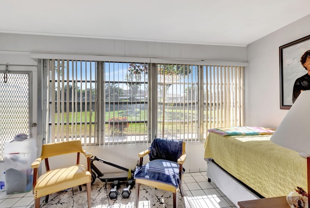 bedroom with tile patterned floors and multiple windows