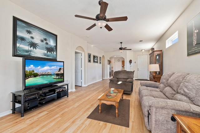 living room with ceiling fan and light hardwood / wood-style flooring