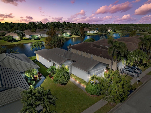 aerial view at dusk with a water view