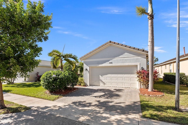 view of front of property featuring a garage and a front yard