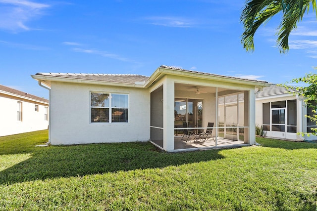 back of property featuring a patio area, a sunroom, and a yard