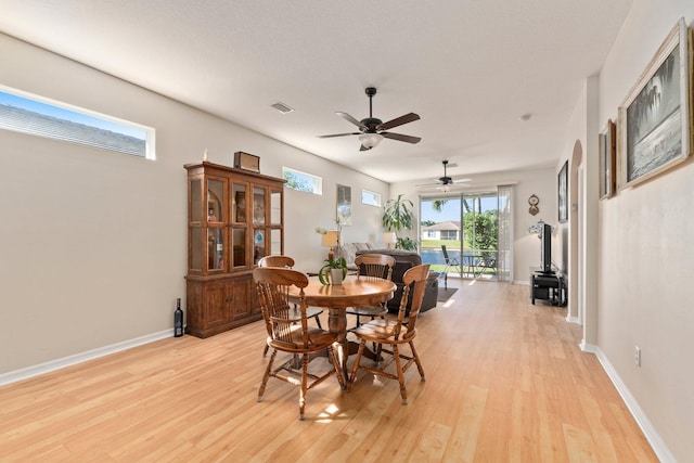 dining area featuring ceiling fan, light hardwood / wood-style floors, and a textured ceiling