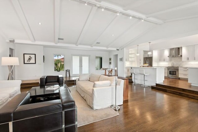 living room with hardwood / wood-style flooring, vaulted ceiling with beams, and french doors