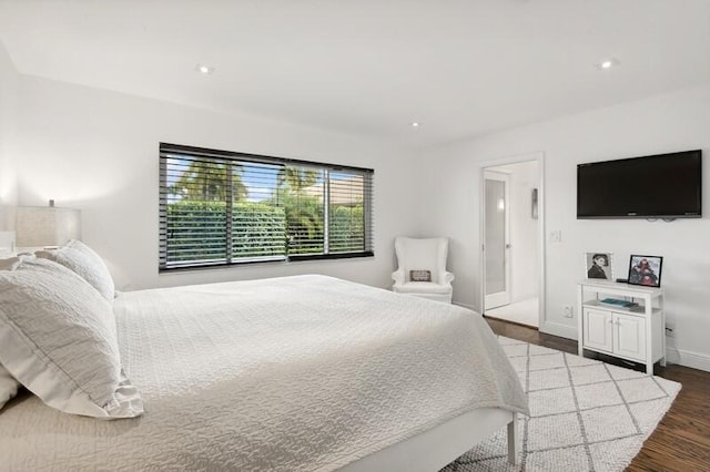 bedroom with dark hardwood / wood-style floors