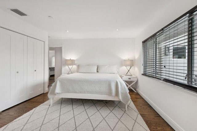 bedroom with a closet and dark hardwood / wood-style flooring