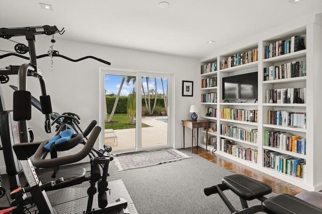 exercise area featuring built in shelves