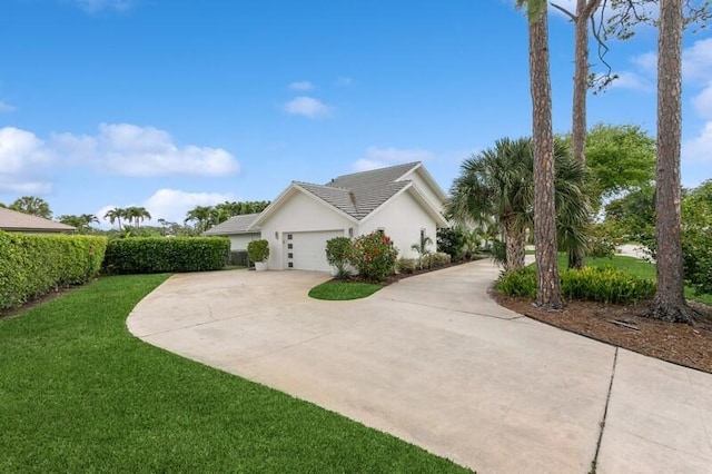 view of side of home with a yard and a garage