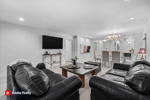 living room featuring an inviting chandelier and light hardwood / wood-style floors