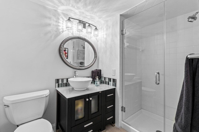 bathroom featuring vanity, toilet, and walk in shower