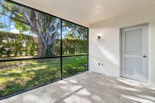 back of house featuring a yard and a sunroom