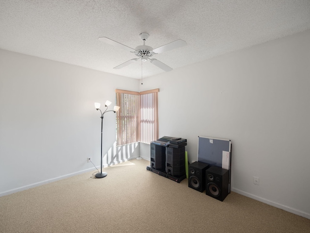 misc room featuring a textured ceiling, ceiling fan, and carpet