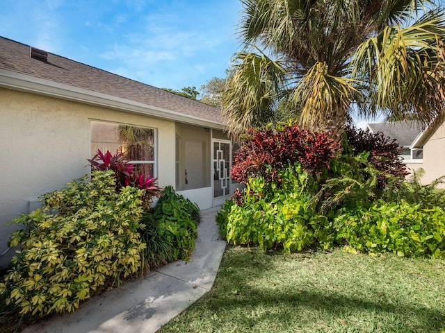 property entrance with a lawn