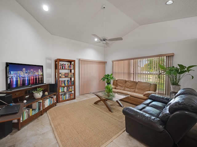 living room with ceiling fan, high vaulted ceiling, and light tile patterned floors