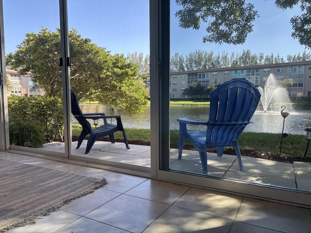 doorway to outside featuring tile patterned flooring and a water view