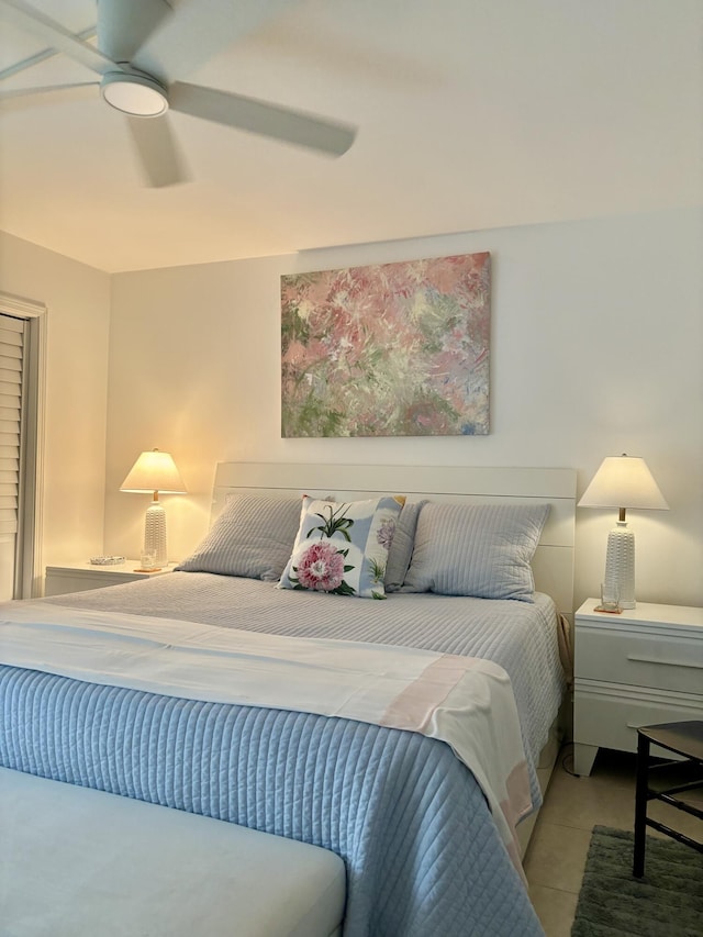 bedroom featuring light tile patterned floors and ceiling fan