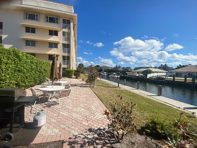 view of patio / terrace featuring grilling area and a water view