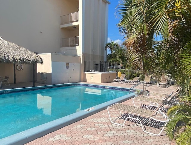 pool featuring a patio and fence