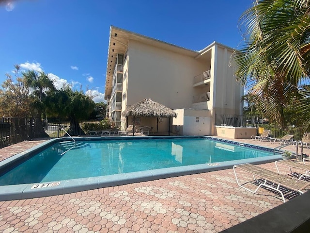 community pool featuring a patio area and fence