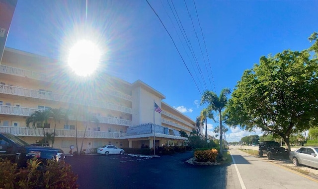 view of building exterior with uncovered parking