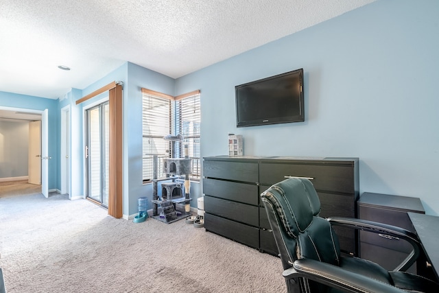 carpeted office featuring a textured ceiling