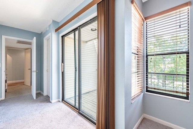 hallway with light colored carpet